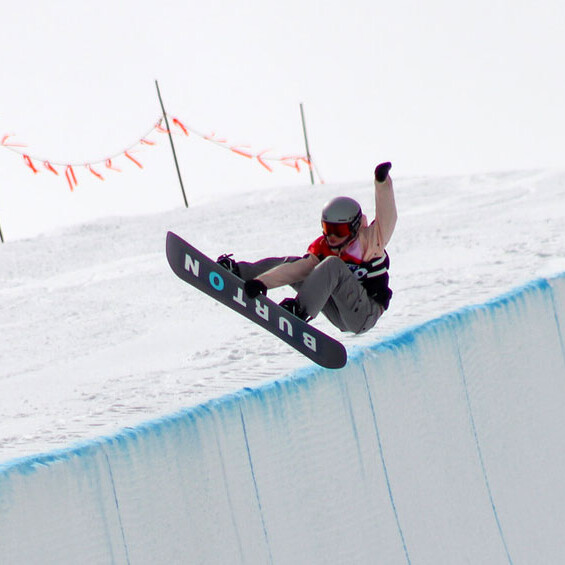 SVSEF snowboard athlete doing a big frontside air in halfpipe.
